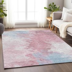 a pink and blue rug in a living room