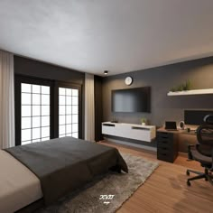 a bedroom with a bed, desk and television on the wall next to a sliding glass door