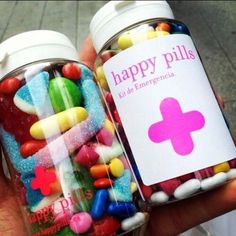 two jars filled with candy and candies next to each other