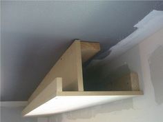 an unfinished shelf in the corner of a room