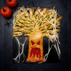 a piece of art made to look like an apple pie with asparagus on it