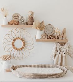 a baby's crib in the corner of a room with shelves above it