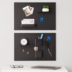 two black pegboard shelves with office supplies on them