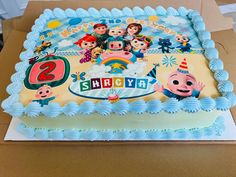 a birthday cake with the characters of toy story on it sitting in a cardboard box