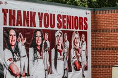 a large poster on the side of a brick building that says thank you seniors