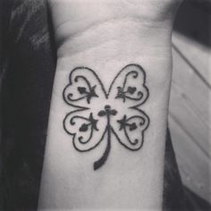 a small clover tattoo on the wrist