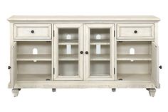 a white cabinet with glass doors and drawers on the bottom shelf is shown against a white background