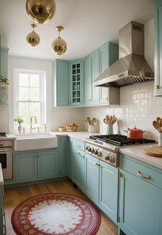 a kitchen with blue cabinets and white counter tops, an area rug in front of the stove