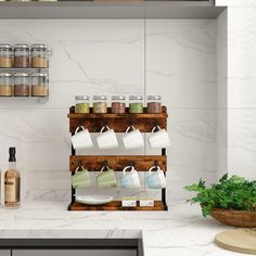 a kitchen counter with spices, coffee cups and other items on the shelves above it