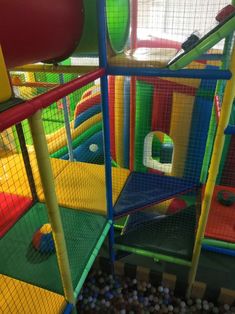 the indoor play area is full of colorful balls and soft plastic structures for children to play in