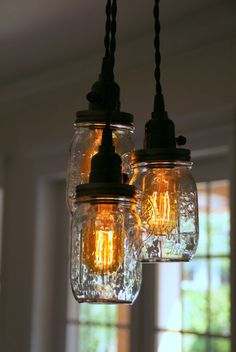 three mason jar lights hanging from a ceiling