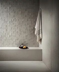 a bath room with a bowl of fruit and towels