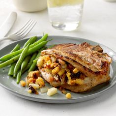 a plate topped with meat and green beans