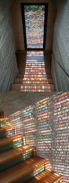 the stairs are covered in multicolored glass tiles and sunlight shining through them,