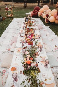 a long table is set with flowers and plates