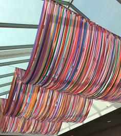 colorful ribbons hanging from the ceiling in a building