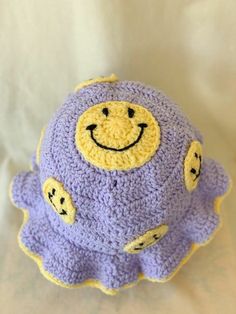 a crocheted stuffed animal with a smiley face