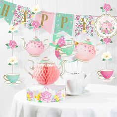 a tea party with pink and green decorations