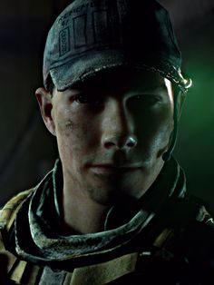 a close up of a person wearing a baseball cap and scarf with green light in the background