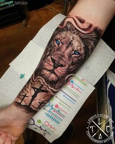 a man's arm with a lion tattoo on it