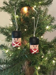 two christmas ornaments are hanging from a tree