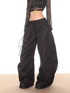 Elevate your casual look with these edgy techwear tactical Black Drawstring Parachute Pants. Complete with an elastic waist and drawstring details, these pants offer a slouchy relaxed fit and wide leg for maximum comfort and style. Perfect for any laid-back occasion. Relaxed slouchy fit Adjustable side drawstrings Elastic waistband Wide-leg, parachute-style silhouette Lightweight nylon material Subtle stitch detailing Model is 5'4 95lbs wearing M Black Overalls, Fall Shoes, Long Sleeve Hoodie, Try On, Denim Pants, Drawstring Waist, Sweater Hoodie, Dress Pants, Parachute Pants