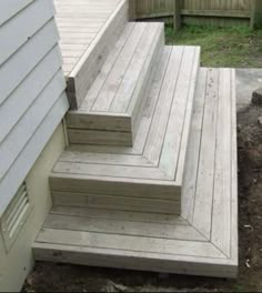 the steps are made out of wood and have been placed on the side of the house