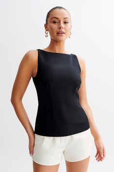 Timeless with a twistThe ANGELA Sleeveless Suiting Top is a sophisticated and versatile piece designed for a polished look. Featuring a boat neckline and contour seam lines, this top creates a flattering and elegant silhouette. The longline cut adds a modern touch, while the sleeveless design ensures comfort and ease of movement. An invisible zip with a hook and eye closure at the back provides a seamless finish. Perfect for both professional and casual settings, this suiting top is a stylish addition to any wardrobe.