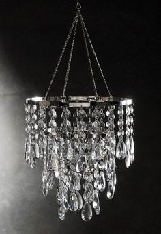 a chandelier hanging from the ceiling with lots of crystal drops on it's chain