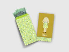 a green and yellow card case with an image of a man in a dress on it