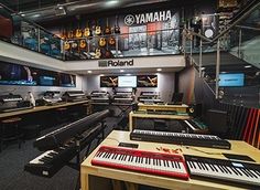 the inside of a recording studio with musical instruments and sound equipment on display in rows