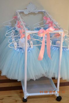 two baby cribs that have pink and blue tulle skirts on top of them