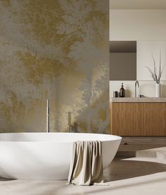 a bath tub sitting next to a sink in a room with a wallpapered background