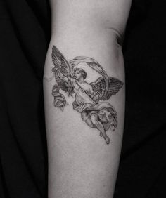 a black and white photo of an angel tattoo on the leg, with flowers around it