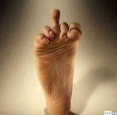 a person's foot is shown with their fingers in the air