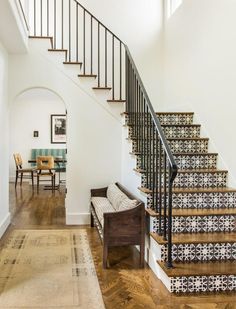 the stairs in this house are decorated with black and white tiles