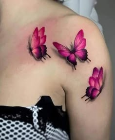 three pink butterflies on the back of a woman's upper half - sleeved shoulder