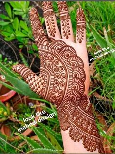 a hand with henna designs on it