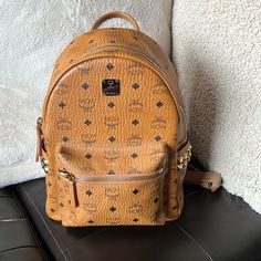 This Listing Is For A Mcm Stark Side Studs Backpack In The Visetos Pattern In The Cognac Color In Mint Condition. The Backpack Was Purchased At Neiman Marcus And Has Only Been Worn 4 To 5 Times And Looks Brand New. Comes With The Dust Bag. Comes From A Smoke-Free And Pet Free Home. Retails For $990. The Official Description From Mcm States The Following: Crafted In Signature Visetos Coated Canvas With A Luxurious Nappa Leather Trim, The Structured Design Features A Spacious Interior And Pyramid Luxury Backpack With Adjustable Strap For Errands, Luxury Backpack With Zipper Closure For Errands, Designer Leather Backpack, Gold Luxury Backpack, Designer Backpack With Gold-tone Hardware For Everyday Use, Gold Standard Backpack, Designer Backpack With Gold-tone Hardware, Mcm Backpack, Studded Backpack