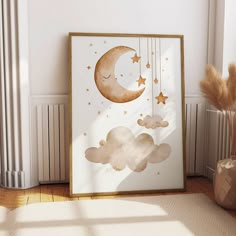 a white and gold framed art print with clouds, stars and the moon