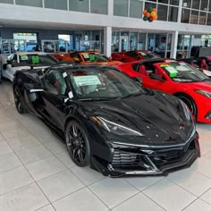 a car showroom filled with lots of different colored cars