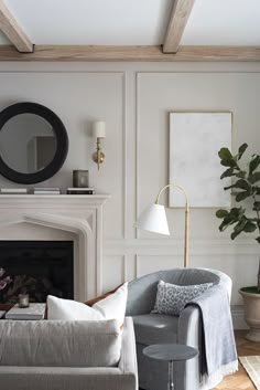 a living room filled with furniture and a fire place in front of a white fireplace