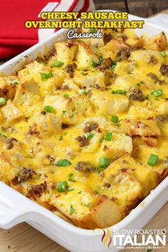 cheesy sausage overnight breakfast casserole in a white dish with green onions