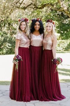 three women in long dresses standing next to each other