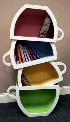 three tiered bookshelf with different colored plates stacked on top of each other