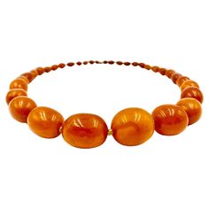 Beautiful, large, natural graduated oval bead antique amber necklace composed of thirty four hand knotted beads 25mm to 6mm, of desirable yellow-orange color with attractive natural variegation. 19th Century Length: 26 inches Amber is fossilized tree resin which has been prized as a gemstone since antiquity. It has been used as jewelry from 13,000 years ago with amber ornaments having been discovered in Mycenean tombs. Amber and amber extracts have been used medicinally in traditional Chinese me Luxury Heirloom Amber Jewelry, Luxury Amber Beads And Cabochons With Natural Stones, Luxury Baltic Amber Necklaces, Luxury Hand-strung Amber Beaded Necklaces, Luxury Artisan Orange Beads, Cheap Amber Necklaces, Luxury Gold Necklace With Baltic Amber, Amber Ornaments, Baltic Amber Necklace