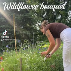 a woman bending over to pick up some flowers in a garden with the words wildflower bouquet above her