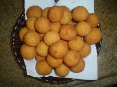 a basket filled with fried food sitting on top of a counter next to a white towel