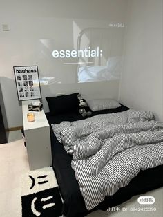 a bed with black and white sheets in a room