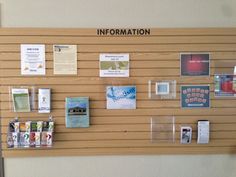 a bulletin board with various items on it and information pinned to the wall behind it